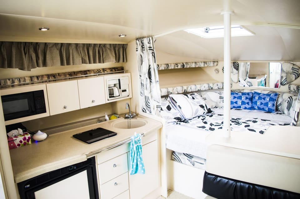 Air-conditioned cabin below, with microwave, coffee maker, sink and fridge to one side and a made-up V-berth forward