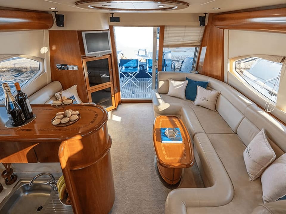 Wider view of a Majesty 50 saloon, showing the seating and the aft doors