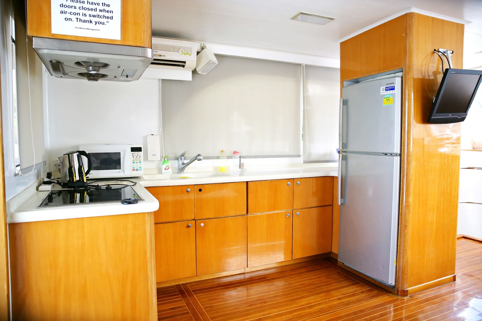 Galley with induction hob, microwave, kettle, sink and the full-height fridge