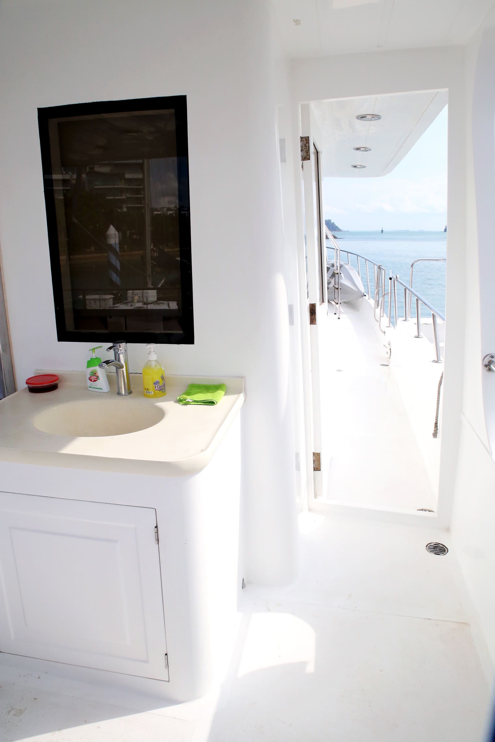 Washroom vanity, with the side deck and open water visible through the doorway