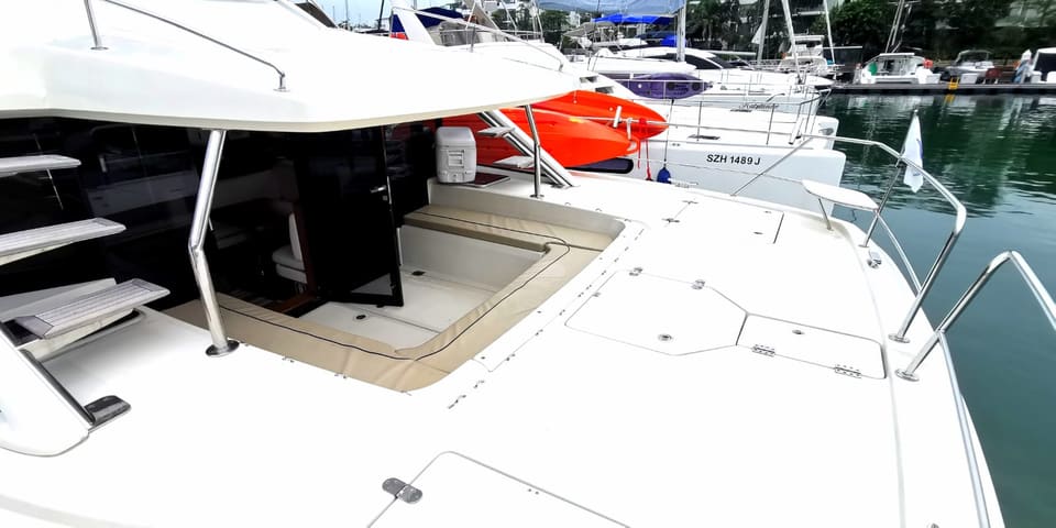 Wide foredeck spanning both hulls, with the tender and cool box stowed forward